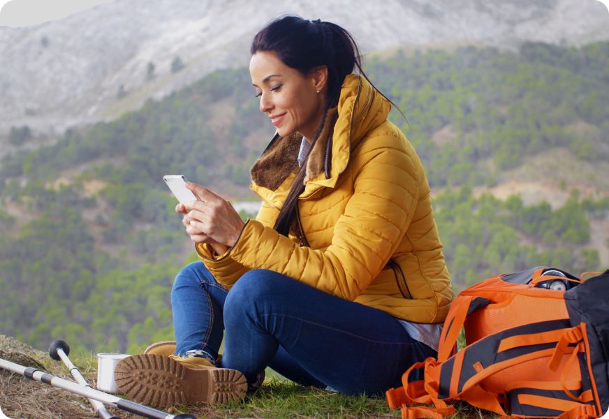 a woman sitting on top of a mountain