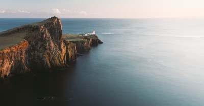 a rocky shore next to a body of water