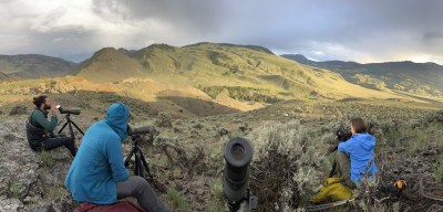 a group of people sitting on top of a mountain